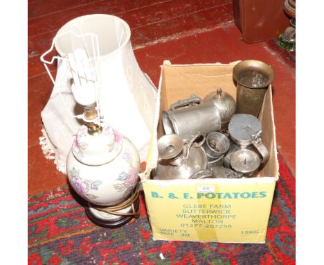 A box of silver plate, pewter and brass along with a baluster shaped table lamp and shade. 