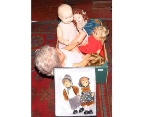 A collection of mid century childrens dolls, along with two hummel style pot girl and boy figures. 