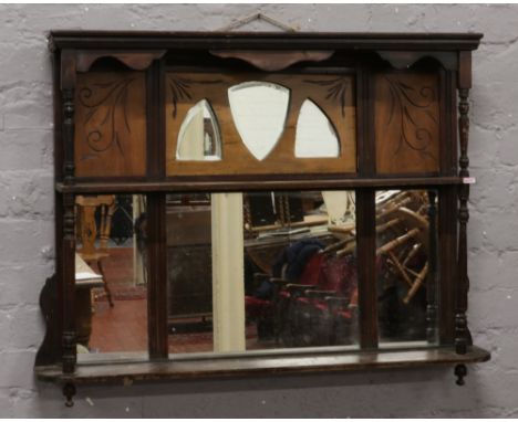 An early 20th century overmantel mirror with turned supports and a two tier shelf. 