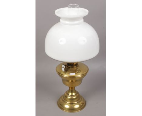 A brass based oil lamp with milchglas shade. 