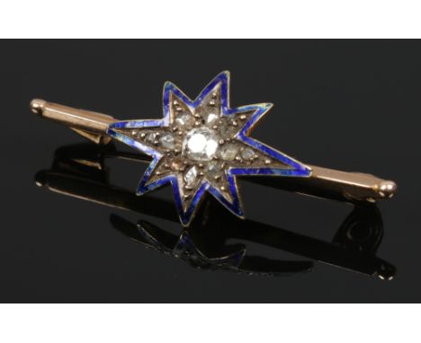 A yellow metal bar brooch. With a starburst centre outlined in blue enamel and set with rose and round cut diamonds. 