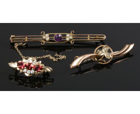 Three 9ct gold brooches. Including seed pearl, amethyst and garnet set examples. 