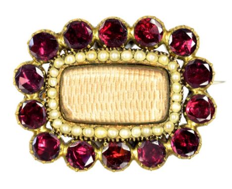 AN EARLY VICTORIAN SPLIT PEARL, FOILED GARNET AND GOLD MOURNING BROOCH