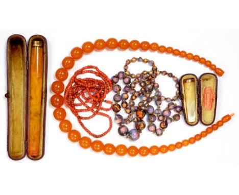 A LONG AMBER CIGARETTE HOLDER, CASED, A GOLD MOUNTED MOTHER OF PEARL CIGARETTE HOLDER, CASED, A NECKLACE OF CORAL BEADS, ETC