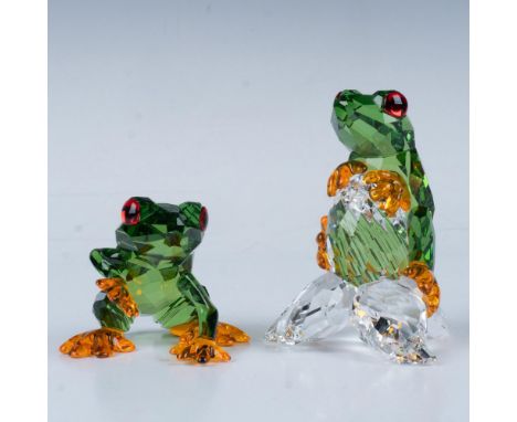Two tree frogs, one resting on a seed and the other relaxing on all fours. This item has its original box. Box measures: 6"L 