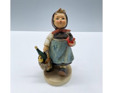 Presents a young girl modeled in a brown and blue dress, delivering a basket with wine and bread, Goebel Hummel backstamp. Is