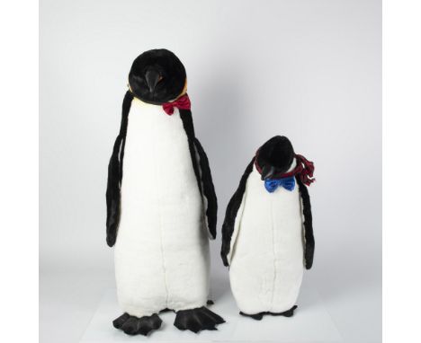 Holiday penguins dressed in bow ties and plaid scarf. Black plush animals with white tuxedo front and hints of yellow. Larges