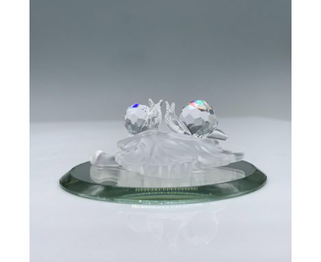 These miniature baby snails are made from clear crystal and are sitting on a frosted crystal leaf. Swarovski swan mark. This 