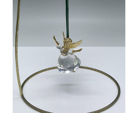 This retired piece was the first in a limited edition series. The angel has gold plated metal head, wings and arms with a len