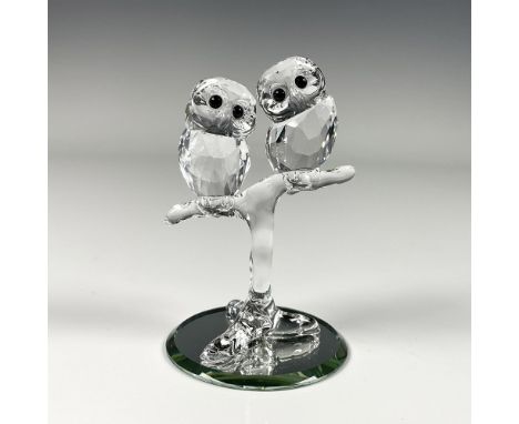 Charming figure featuring two small owls on a branch, crafted from clear crystal. Swarovski swan mark. This item includes a m