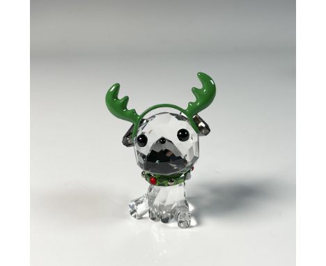 Adorable figure pug, crafted from clear crystal and adorned with a Santa headband and a necklace featuring a green accent, ca