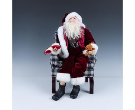 Porcelain Father Christmas (9.5"L x 6.5"W x 20"H) is hand crafted and dressed in velveteen burgundy suit holding a stocking a