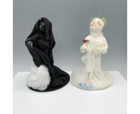 Vintage ethereal duo of figures from the classic Charles Dickens story A Christmas Carol that depicts a figure holding holly 