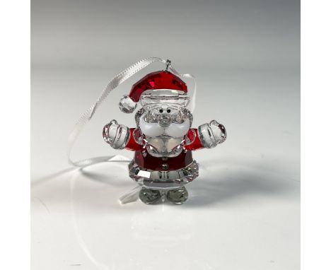 Delightful Christmas tree ornament featuring Santa Claus, crafted from clear crystal with red accents. Swarovski swan mark. T