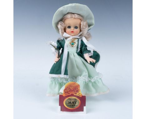 Small adorable figure of a girl wearing an emerald colored dress and gem. This item has its original box 6"L x 3"W x 7.5"H. D