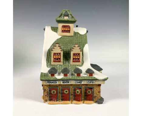 Hand painted porcelain house titled Reindeer Stables from the Heritage Village Collection. This festive piece features a snow