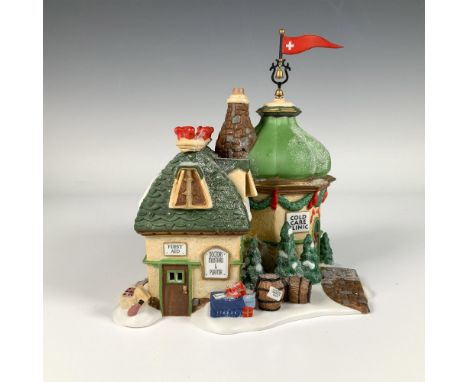 Hand painted porcelain building, the Cold Care Clinic features a charming structure with snow dusted roofs, a large green dom