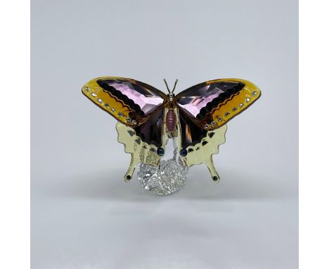 A stunning butterfly crafted from pale-yellow, purple, and orange crystals. Gold-tone metal, and black and pink lacquered acc