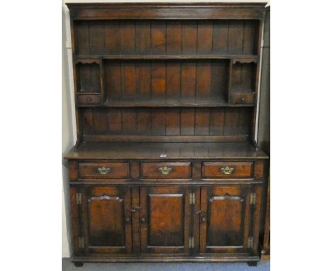 A Titchmarsh &amp; Goodwin, Georgian mid Wales style oak dresser, model RL-19855, with delft rack, featuring spice cupboards 