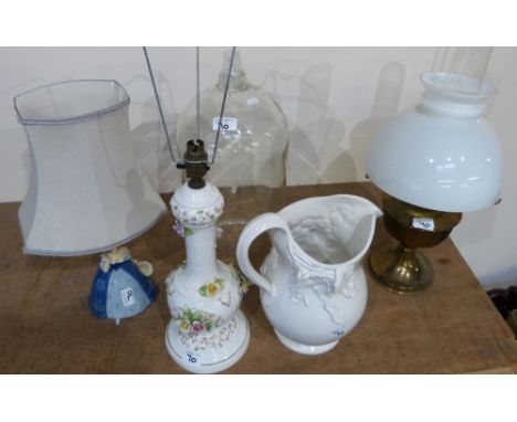 A large white ceramic jardinière on stand together with matching jug, oil lamp, two table lamps and a large demijohn with two