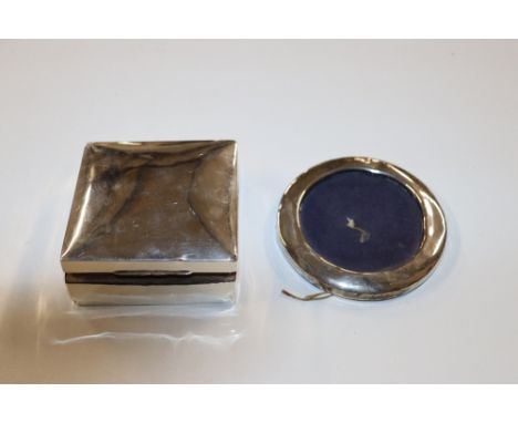 A circular silver photo frame together with a silver trinket box