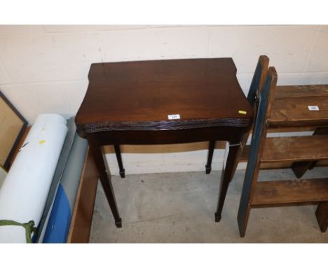 A mahogany card table, raised on square tapering supports terminating in spade feet