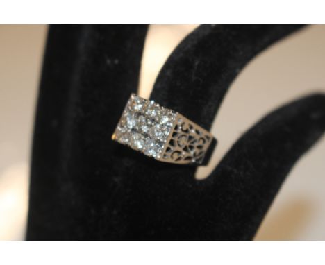 A white metal and diamond set ring, set with nine approx. .015ct diamonds, ring size Q, total weight 6gms
