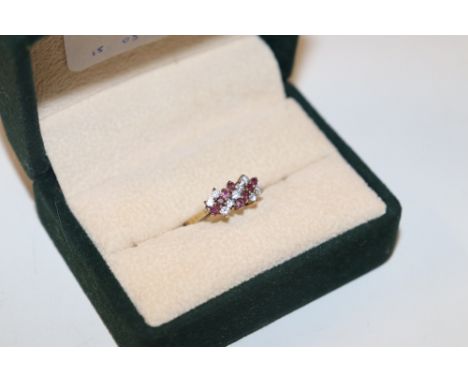 A 9ct gold dress ring set with red and white stones, ring size L/M, approx. weight 2gms