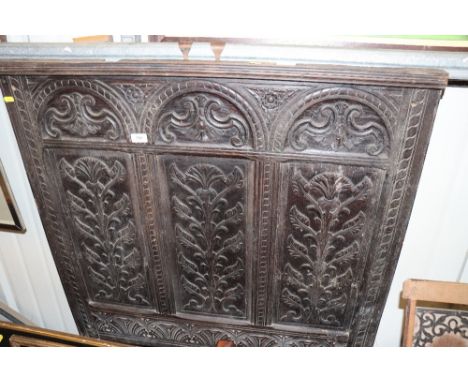 An antique carved oak panel
