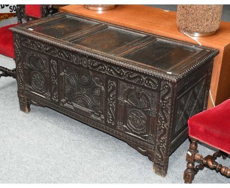 An 18th century carved oak three panel coffer initialed M.O 134cm by 56cm by 66cmHinges replaced, top left right panels split