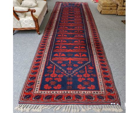 Bergama runner, the indigo field with columns of stylised plants enclosed by brick red borders 497cm x 130cm