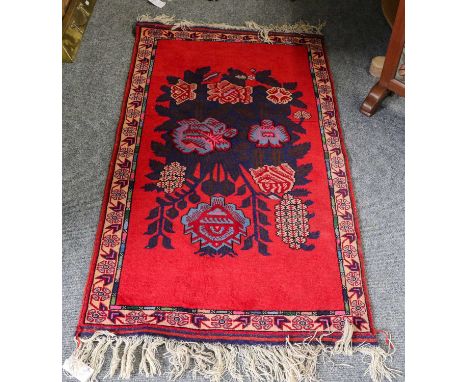 Mushwani Balouch khorgreen, each face with a latch hook medallion enclosed by barber pole? borders, 179cm by 78cm; together w