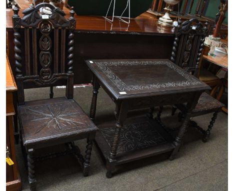 A lunette carved two tier oak lamp table, 76cm by 52cm by 72cm; together with a pair of similar carved oak hall chairs