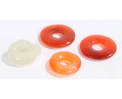 Chinese loops, to include three carnelian examples and a joined pair of jade examples, (4)