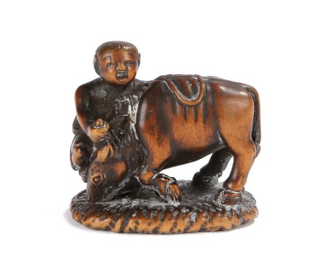 Japanese Meiji period signed netsuke, the wood netsuke depicting Boy with Ox, the boy appearing to be pulling the ox down. si
