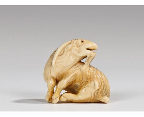 Fine Japanese Edo period netsuke, the ivory netsuke carved as a Kyoto goat, seated and looking to the rear signature to the b