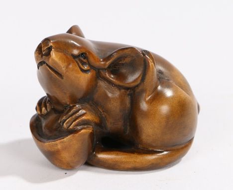 Japanese wood netsuke, as a rat crouched above an open nut, signed to the base, 4.5cm long