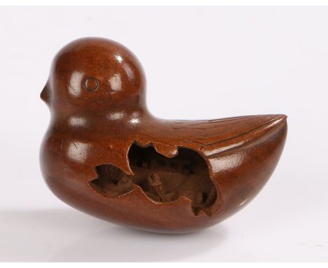 Japanese Meiji period boxwood netsuke, carved as a bird with an internal carving of figures in a boat, 4.4cm long