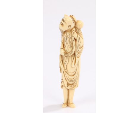 Japanese Edo period ivory netsuke, the standing figure clutching a robe, 11cm high