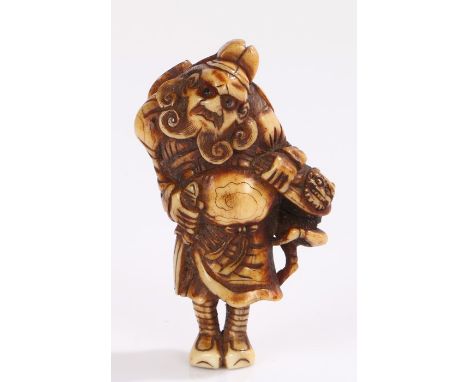 Japanese Edo period ivory netsuke, standing Samurai, with two old collection labels to the back, 7cm high