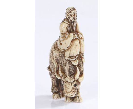 Japanese Edo period ivory netsuke, 18th Century, carved as a figure riding a buffalo, 6.5cm high