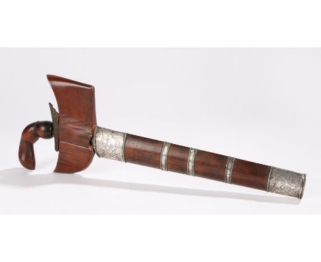 19th Century Balinese Kris, with a carved grip and wide shoulder with white foliate decorated mounts to the scabbard housing 