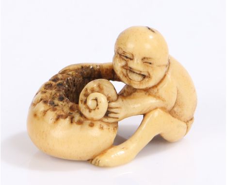 Japanese Edo period bone netsuke, 18th Century, of a laughing boy with the tentacle of a giant octopus, 3.4cm. Provenance: Po