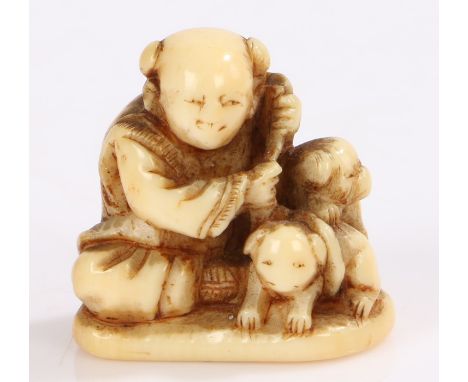 Japanese Edo period ivory netsuke, 18th Century, seated boy holding two puppies, 2.4cm high. Provenance: Popular Art in Isola