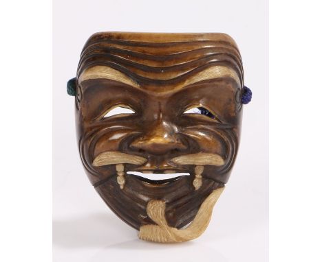 Japanese Meiji period stained ivory netsuke, of a Noh mask 5cm high