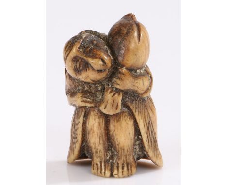 Japanese Edo period bone netsuke, monkey clasping a large peach, 4.3cm high. Provenance: Popular Art in Isolation Japan 1639-