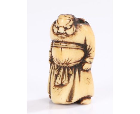 Japanese Edo period bone netsuke, carved a figure in long robes clutching a sword, 5cm high