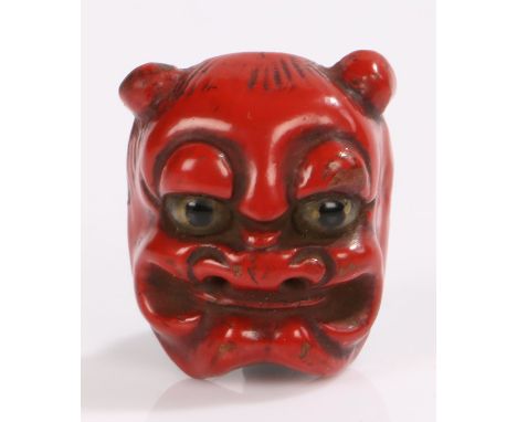 Japanese Meiji period lacquered netsuke, Noh mask in red with black eyes, 3.6cm high