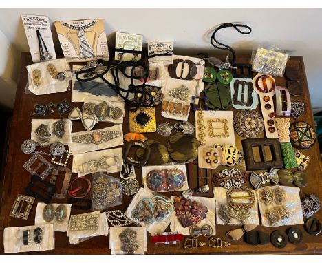 A large quantity of vintage dress and belt buckles including enamel, skirt lifters, hat guards etc. 