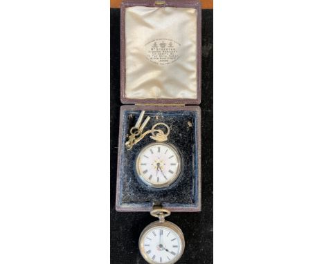 Two white metal pocket watches marked .800 and .935. Both with white enamel faces. One in original fitted leather case. 